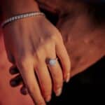 a close up of a person holding a diamond ring