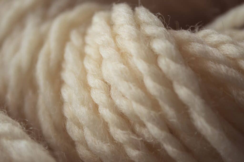 Macro of cream thread of wool with white background