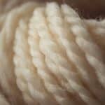Macro of cream thread of wool with white background