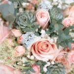 a bridal bouquet of pink roses and succulents