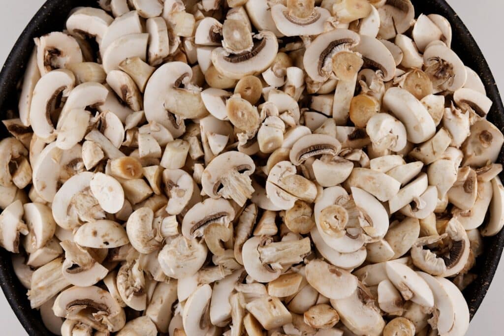 sliced fresh mushrooms in a pot