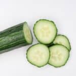 sliced cucumber on white surface