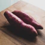 two red sausage on brown wooden chopping board