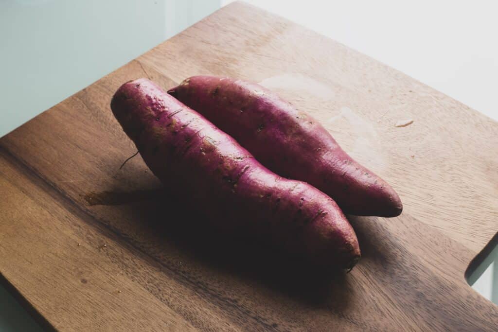 two red sausage on brown wooden chopping board