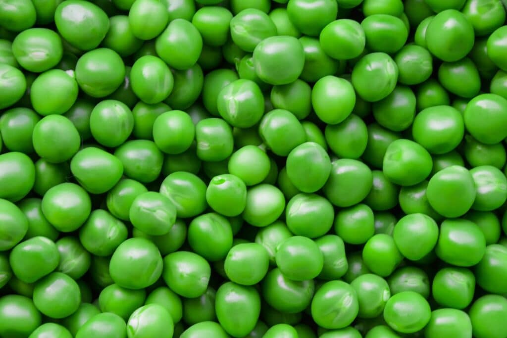 full plate of green beans on the white desk